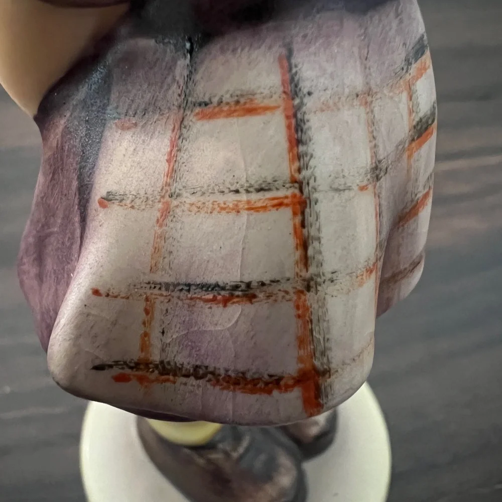 Charming Figurine with Purple and Brown Accents